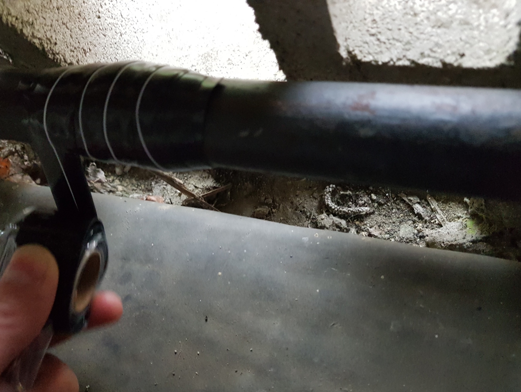 Wrap & Seal Pipe Burst Tape being applied to seal a leak in a malleable iron water pipe at a UK home